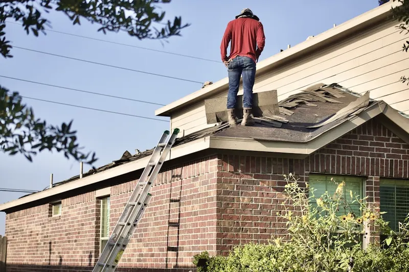 Professional roofer working on a residential roof in Rampasture